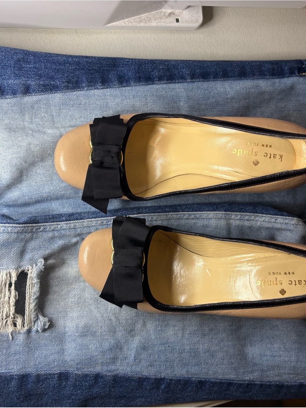 kate spade tan leather flats with black trim and bow